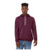 A man wearing a maroon Bella + Canvas sponge fleece hoodie.