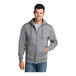 A man wearing a Port & Company full-zip athletic heather hoodie.