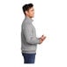 A man wearing a Port & Company athletic heather quarter-zip pullover.