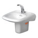A white sink with a silver faucet on a counter.