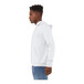 A person wearing a white Bella + Canvas sponge fleece pullover hoodie.