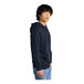 A man wearing a navy blue District hoodie with a drawstring.