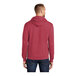 A man wearing a heather red Port & Company Core Fleece pullover hoodie.