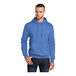 A man wearing a Port & Company heather royal blue fleece pullover hoodie.