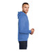 A person wearing a Port & Company heather royal blue pullover hoodie.