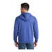A man wearing a heather royal blue Port & Company Core Fleece full-zip hoodie.