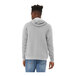 A man wearing a Bella + Canvas grey sponge fleece pullover hoodie.