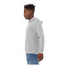 A man in a Bella + Canvas athletic heather grey sweatshirt with his hands on his hips.