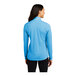 A woman wearing a Sport-Tek quarter-zip pullover in pond blue.