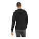 A person wearing a black Bella + Canvas full-zip hoodie.