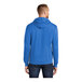A person wearing a blue Port & Company Core Fleece pullover hoodie.