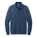 A navy Nike Dri-FIT half-zip sweater with a white swoosh.