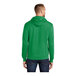 A man wearing a green Port & Company Core Fleece hoodie.