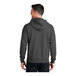 A man wearing a charcoal Port & Company Core Fleece full-zip hoodie.