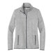 A Port Authority women's light gray fleece sweater jacket with a zipper.