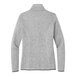 A close-up of a Port Authority women's grey fleece sweater jacket with a zipper.