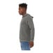 A person wearing a Bella + Canvas deep heather grey sponge fleece pullover hoodie.