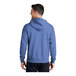 A man wearing a Carolina blue Port & Company Core Fleece full-zip hoodie.