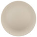 An Elite Global Solutions Papyrus-colored round melamine plate with a plain edge on a white surface.