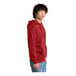 A person wearing a red District hoodie.