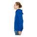 A person wearing a Bella + Canvas True Royal Sponge Fleece full-zip hoodie in blue.