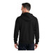 A man wearing a Port & Company black fleece full-zip hoodie.