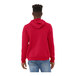 A person wearing a red Bella + Canvas sponge fleece pullover hoodie.