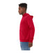 A person wearing a red Bella + Canvas pullover hoodie.