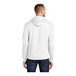 A man wearing a white Port & Company fleece pullover hoodie.