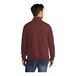 A man wearing a maroon Port & Company quarter-zip sweatshirt.