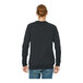 A man wearing a dark gray Bella + Canvas Sponge Fleece raglan sweatshirt.