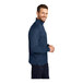 A man in a blue Port Authority quarter-zip pullover.