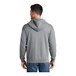 A man wearing a Port & Company athletic heather grey full-zip hoodie.