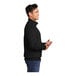 A man wearing a Port & Company black core fleece quarter-zip pullover.