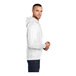 A man wearing a white Port & Company fleece pullover hoodie.