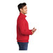 A man wearing a red Port & Company quarter-zip fleece sweatshirt.