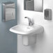 A white sink with a silver faucet and a WizKid Cotton Blossom air freshener on the counter.