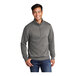 A man wearing a Port & Company graphite heather quarter-zip pullover sweatshirt.