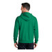 A man wearing a green Port & Company full-zip hoodie.