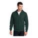 A man wearing a dark green Port & Company full-zip hoodie.