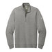 A gray Nike Dri-FIT half-zip sweater with a white swoosh.