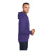 A man wearing a purple Port & Company Core Fleece pullover hoodie.