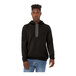 A man wearing a black Bella + Canvas sponge fleece pullover hoodie.