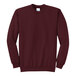 A maroon Port & Company Core Fleece sweatshirt with a white logo on the front.