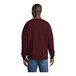 A man wearing a maroon Port & Company core fleece sweatshirt.