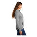 A woman wearing a Port & Company athletic heather fleece pullover hoodie.