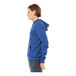 A man wearing a Bella + Canvas blue sponge fleece full-zip hoodie.