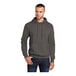 A man wearing a Port & Company charcoal pullover hoodie made from a soft cotton blend.