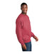 A man wearing a Port & Company heather red sweatshirt.