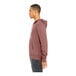 A man wearing a mauve Bella + Canvas full-zip hoodie.